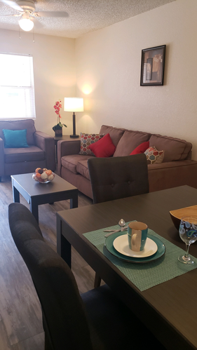 El Paso apartment for rent - A living room with a brown couch, a coffee table, and a lamp.