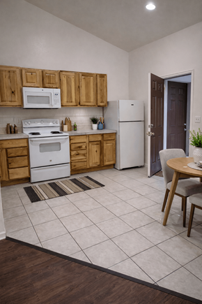Denver apartment for rent - A kitchen with wooden cabinets and white appliances.