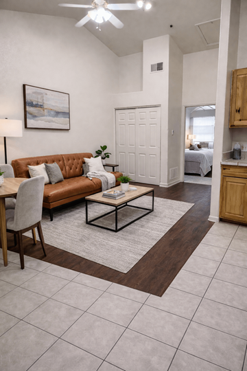 Denver apartment for rent - A living room with a brown couch and a white ceiling fan.