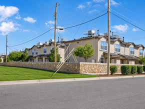 El Paso apartment for rent - A row of houses with a stone wall in front.