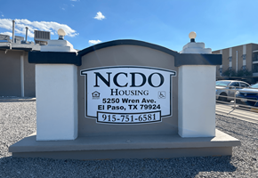 El Paso apartment for rent - the sign for ncdo housing in front of a parking lot