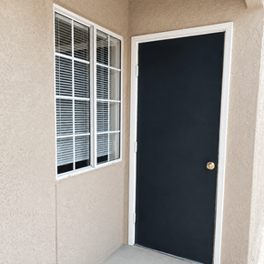 El Paso apartment for rent - A black door with a gold knob is on the right and a window with white blinds is on the left.