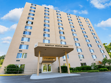 Nashville apartment for rent - A large building with a beige facade and a sign that reads "Haslev Christian Towers".