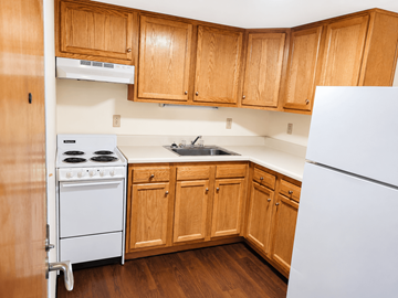 Nashville apartment for rent - A kitchen with wooden cabinets and a white refrigerator.
