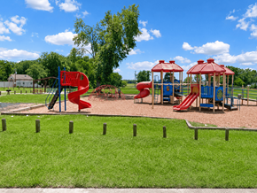 Shreveport apartment for rent - A playground with a red slide and a blue slide.