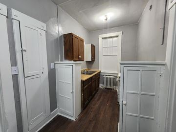 Memphis apartment for rent - A kitchen with white cabinets and a wooden counter.