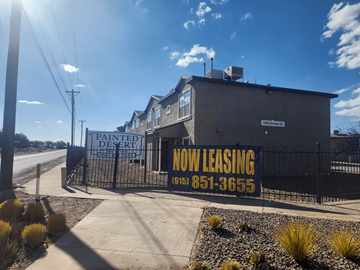 Clint apartment for rent - A sign for a Painted Desert motel is displayed in front of a building.