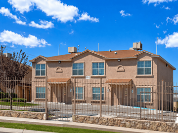 Clint apartment for rent - A large house with a brown roof and a pool in the front yard.