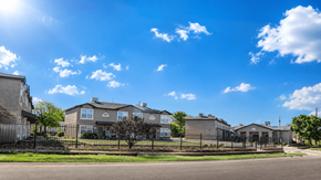 Clint apartment for rent - A row of houses with a clear blue sky above them.