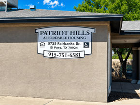El Paso apartment for rent - A sign for Patriot Hills Affordable Housing is on the side of a building.