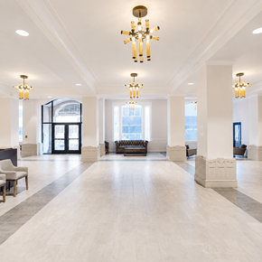 Chattanooga apartment for rent - A large, well-lit lobby with a chandelier and a bench.