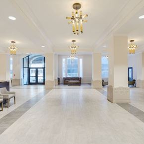 Chattanooga apartment for rent - A large, well-lit lobby with a marble floor and a chandelier hanging from the ceiling.