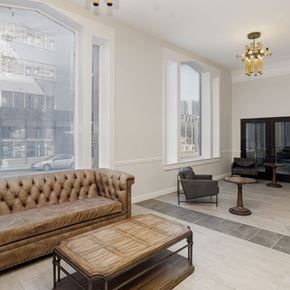 Chattanooga apartment for rent - A brown tufted sofa sits in a room with a wooden coffee table in front of it.