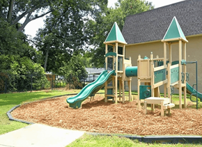 Baton Rouge townhouse for rent - A playground with a green slide and wooden structure.