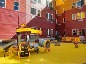 Denver apartment for rent - A playground with a yellow slide and orange barriers.