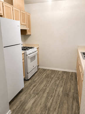 El Paso apartment for rent - A kitchen with a white refrigerator and a white stove top oven.