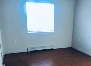 Aurora apartment for rent - an empty room with a window and wooden floors