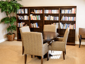 Dublin apartment for rent - A room with a large bookshelf filled with books and a table with chairs.