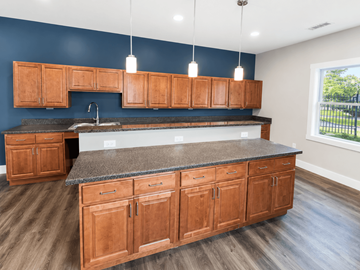 Rockford apartment for rent - A kitchen with wooden cabinets and a granite countertop.