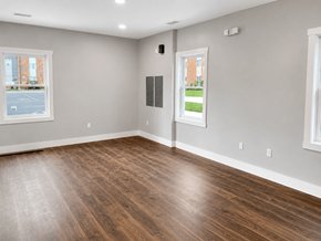 Rockford apartment for rent - A room with wooden flooring and two windows.