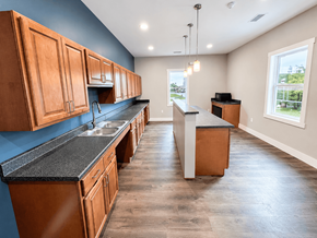 Rockford apartment for rent - A kitchen with wooden cabinets and a black countertop.