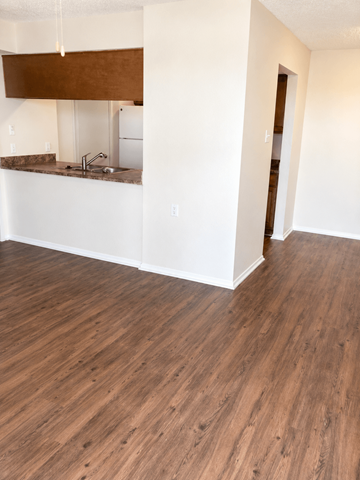 Ft. Worth apartment for rent - A kitchen with a white counter and brown cabinets.