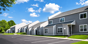 Lexington townhouse for rent - A row of modern houses with grey exteriors and white roofs.