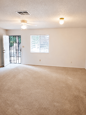 El Paso apartment for rent - A room with a carpeted floor and a ceiling fan.