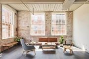 Prattville apartment for rent - A living room with a brick wall and wooden furniture.