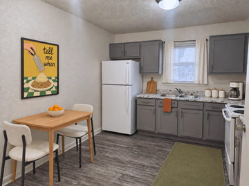 Oklahoma City apartment for rent - A kitchen with a white refrigerator, a table with chairs, and a painting on the wall.