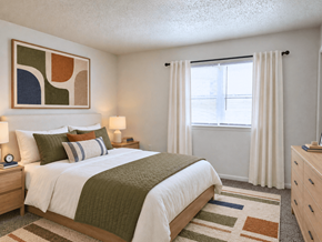 Oklahoma City apartment for rent - A bedroom with a bed, nightstand, and a painting on the wall.