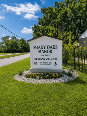 Ft. Worth apartment for rent - A sign for Shady Oaks Manor Apartments is displayed in front of a fence.