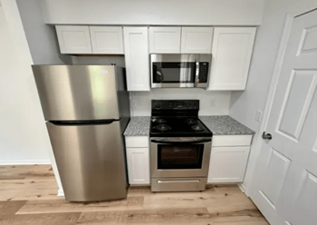 Kitchen with stainless steel appliances and white cabinets