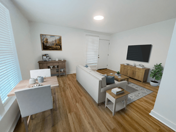 A living room with white furniture and a tv