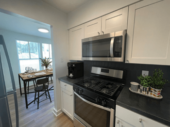 A kitchen with a stove and a microwave