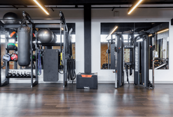 A fitness room with weights and equipment in a gym