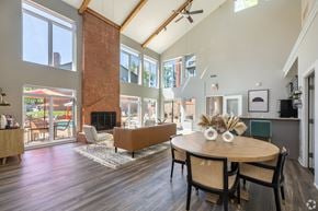 St. Louis apartment for rent - A modern dining room with a wooden table and chairs.
