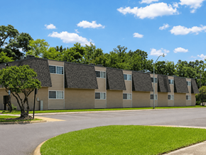 Baton Rouge townhouse for rent - Apartment complex with a tree in front of it.