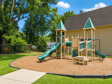 Baton Rouge townhouse for rent - A playground with a green slide and wooden structure.