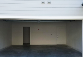 Tupelo townhouse for rent - an empty garage in a building with a door
