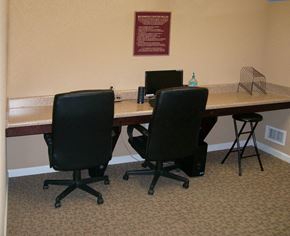 Shelbyville apartment for rent - a desk with two chairs and a computer on it