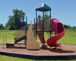 Shelbyville apartment for rent - a playground with a red playset with a yellow and red slide