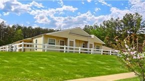 Little Rock apartment for rent - a yellow house with a white fence and green grass