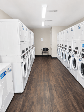 Little Rock apartment for rent - A laundromat with rows of washers and dryers.