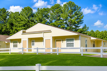 Little Rock apartment for rent - A yellow house with a white fence in front of it.