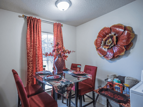 Memphis apartment for rent - a dining room with a table and chairs and a large flower on the wall