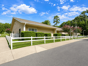 Little Rock apartment for rent - A house with a white fence and a driveway in front.