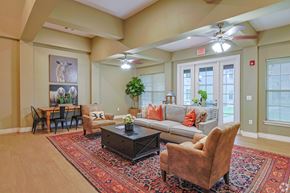 Bastrop townhouse for rent - A living room with a rug, a couch, a coffee table, and a dining table.