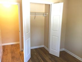Baltimore apartment for rent - A white door is open to a room with a wooden floor.