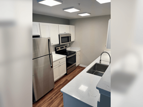 Walls apartment for rent - a kitchen with white cabinets and stainless steel appliances